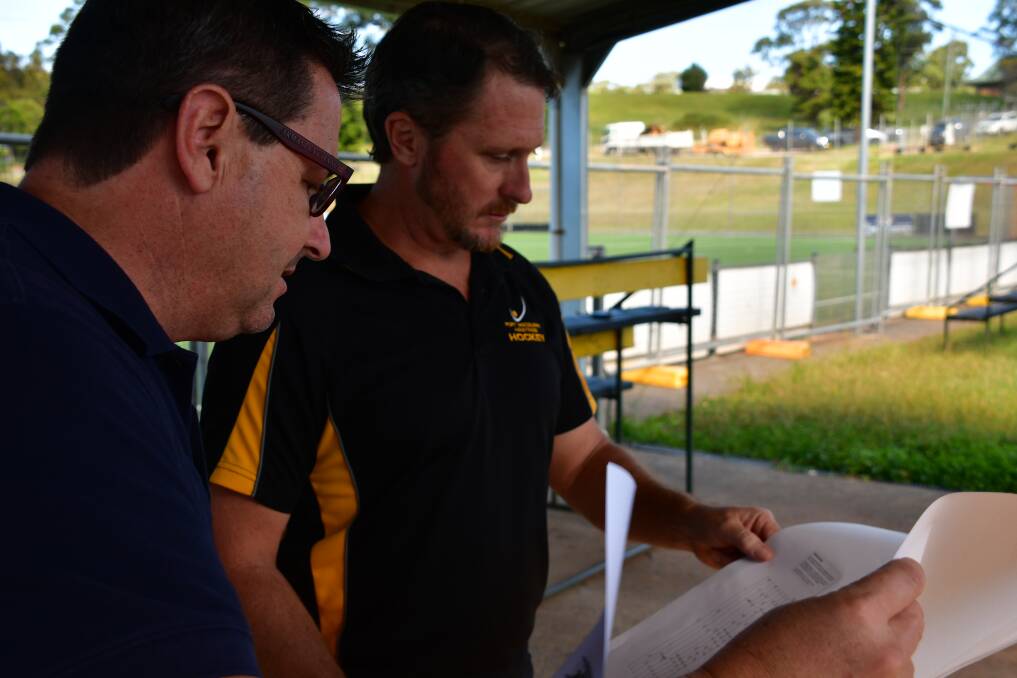 New start: Federal member for Cowper Pat Conaghan and Port Macquarie-Hastings Hockey Association president Simon Thresher browse the plans for the new hockey clubhouse.