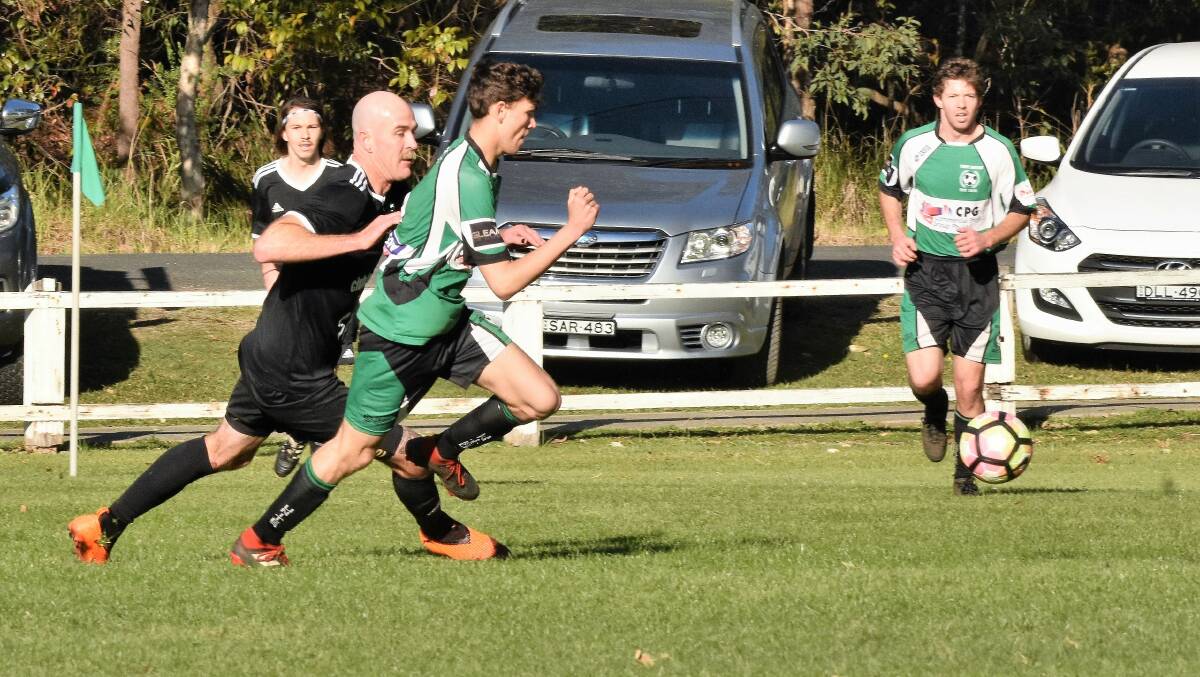 Jostling for possession: Troy Berecry leads the race for the ball against Wallis Lake on Saturday.