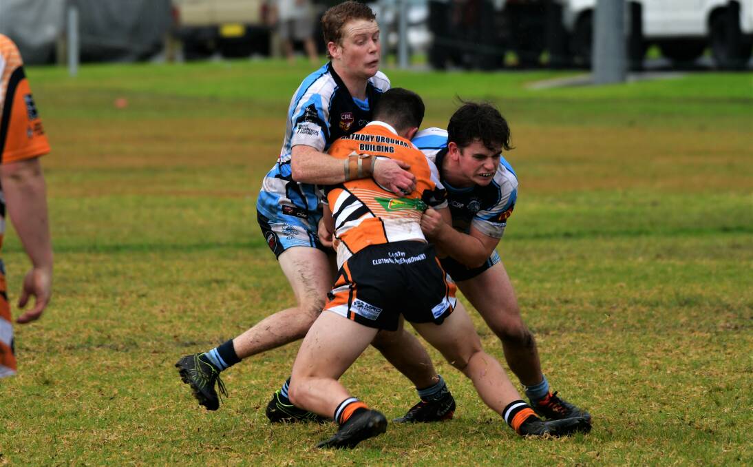Defensive work: Sam Nunan and Luke Mapstone combine to make a tackle during Port City's disappointing 18-0 loss to Wingham on Saturday. Photo: Paul Jobber