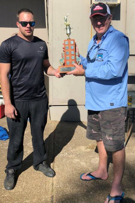 Kane Love (L) being presented with the Dawn Pardoe Memorial Trophy by president Geoff Shelton