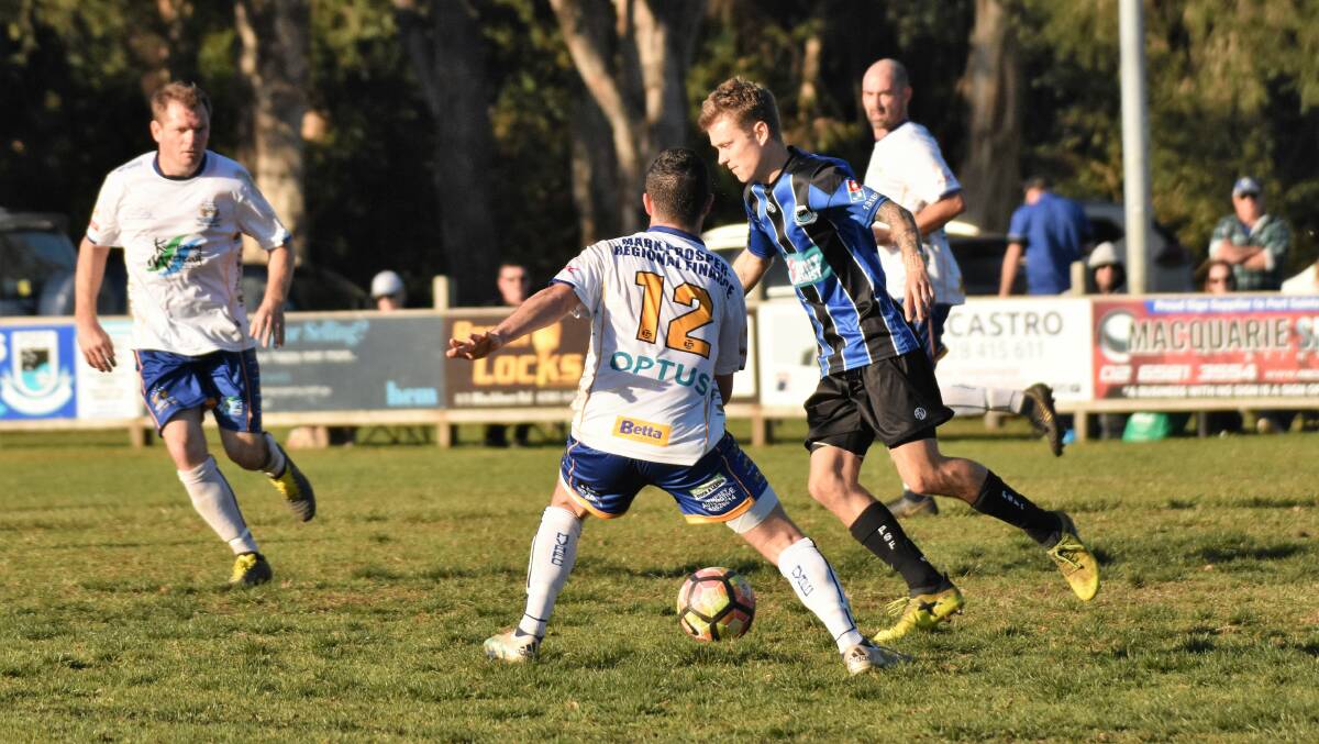 Quick feet: Michael Bishop takes on the Macleay Valley defence on Saturday.