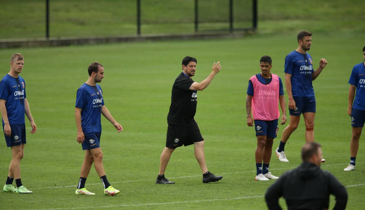 Work to do: Jets coach Arthur Papas (centre) and Angus Thurgate (left) at training last week. Photo: Jonathan Carroll.
