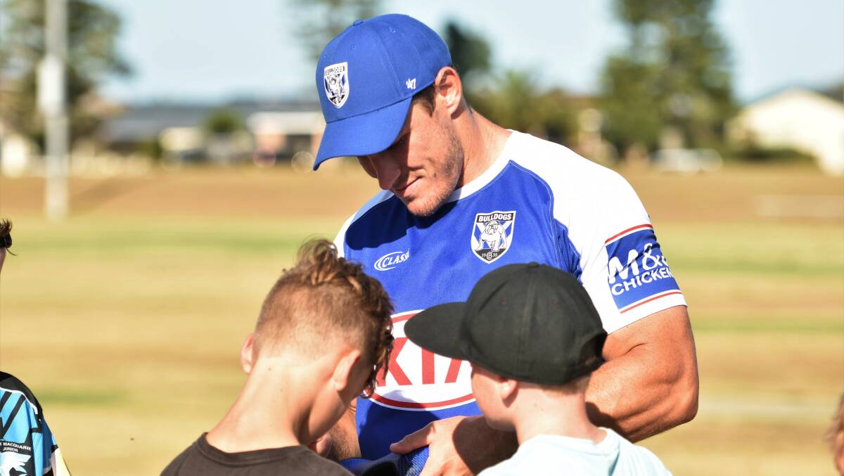 Star power: Josh Jackson signs an autograph in Port Macquarie on Tuesday. Photo: Paul Jobber