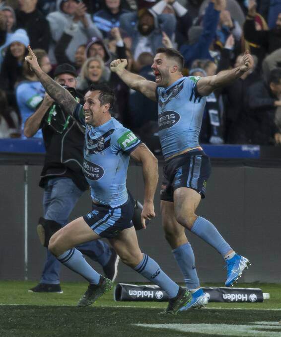At last: Mitchell Pearce celebrates with James Tedesco after the Blues' pulsating 26-20 Origin deciding victory. Photo: AAP Image/Craig Golding
