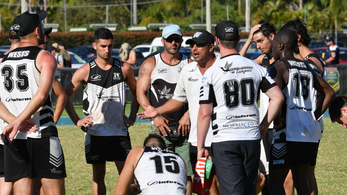 We go again: Coach Tony Trad (centre) talks to his players following their loss in last year's final.