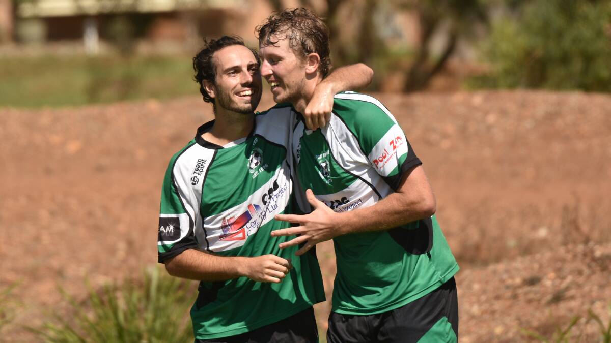 Moving up: Matt Bale celebrates with Matt Broderick during Port United's FFA Cup loss to Boambee. Mid North Coast clubs will face Coffs Harbour opponents from 2020. Photo: Paul Jobber