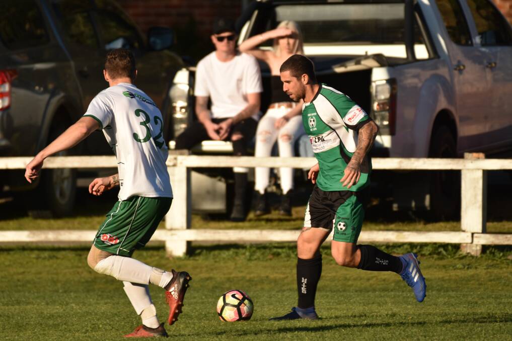 Tricky feet: Port United's Adam Woonton takes on the Kempsey Saints defence.