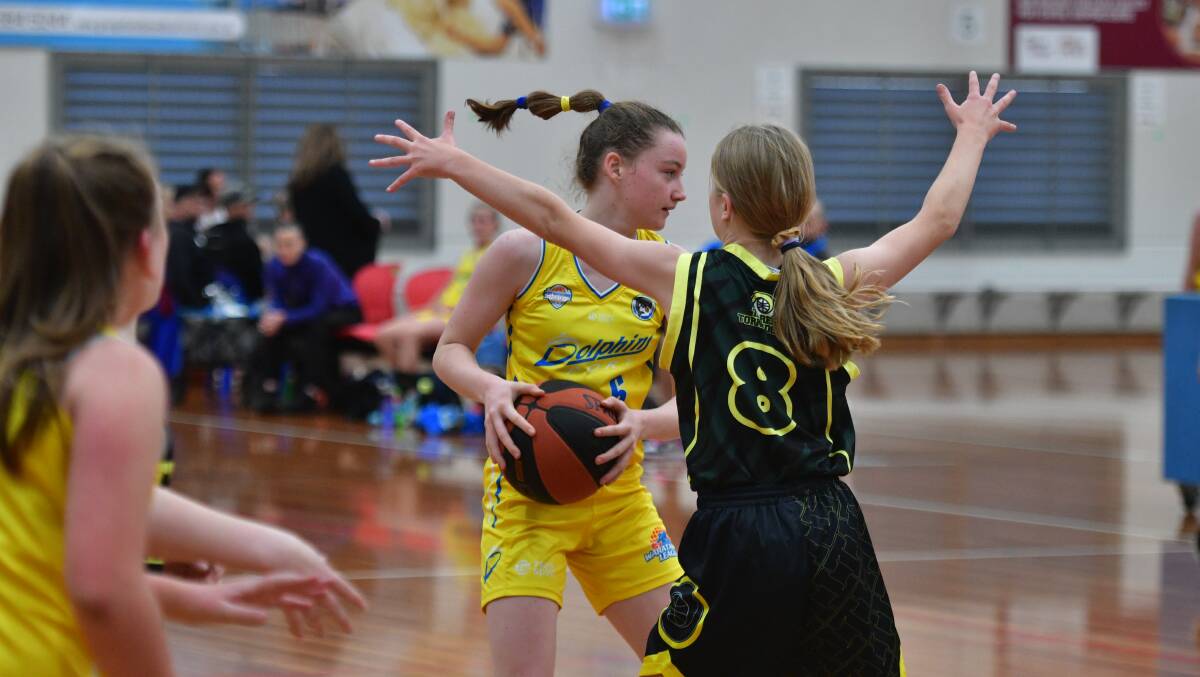 Make space: Dolphins under-14 player Cara McIlroy searches for support.