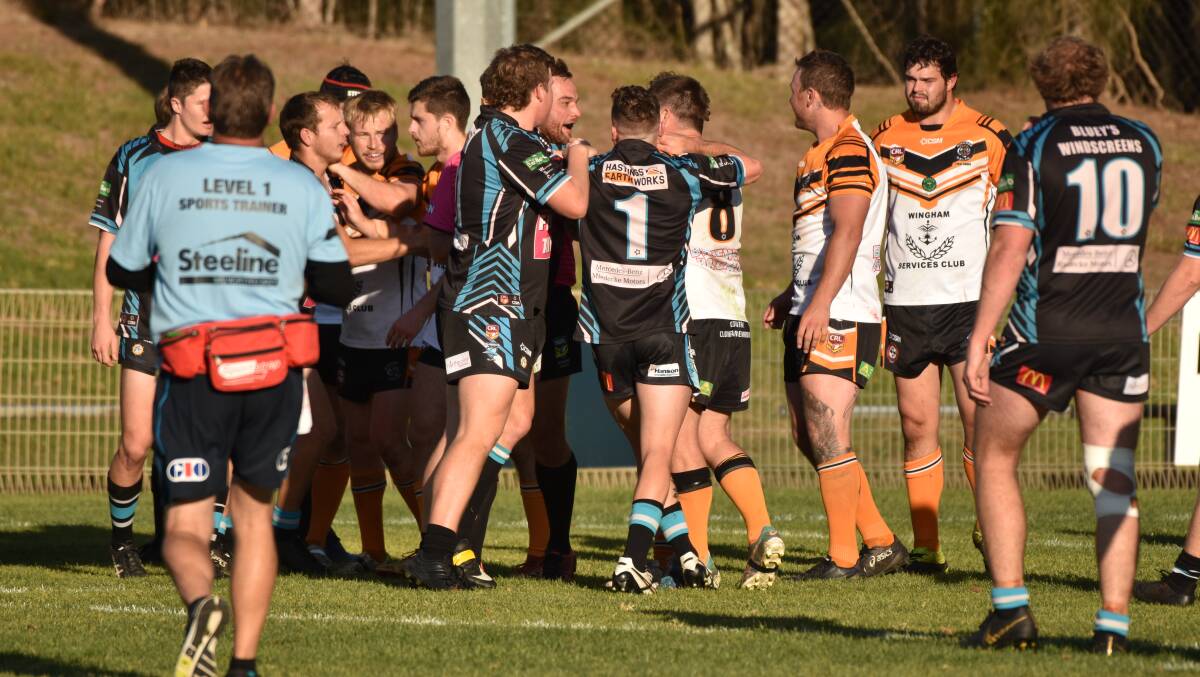 Fiery encounter: Sharks and Wingham players exchange pleasantries on Saturday.