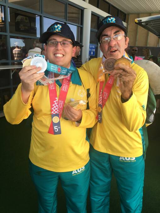 All ours: Jason Holley and Darren Wallis show off their medals from the Special Olympics. Photo: supplied