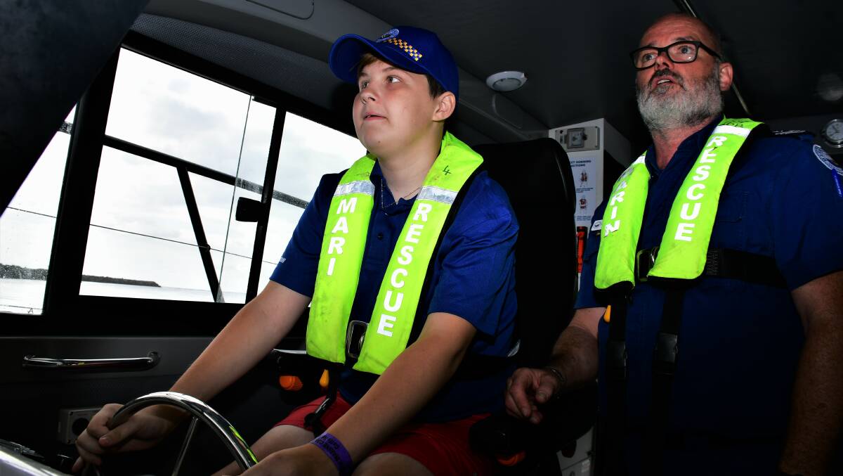 Bucket list item: Jake Spurdle (left) behind the controls of a Port Macquarie Marine Rescue vessel on March 10 as Rob Breskal watches on. Photo: Paul Jobber
