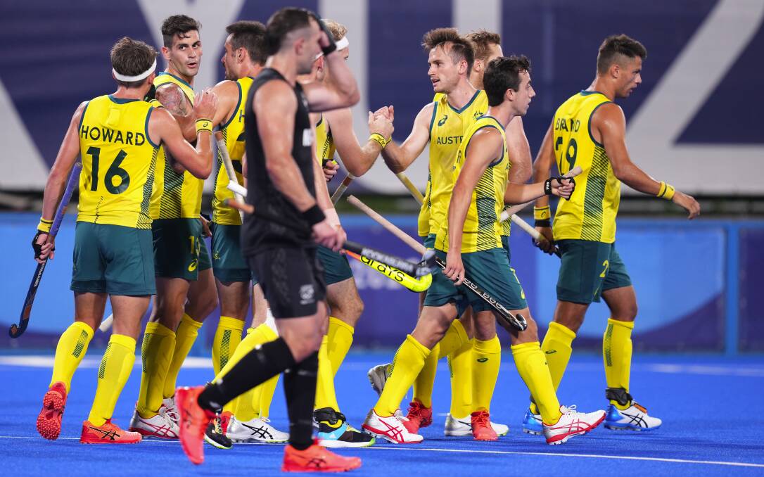 On song: Australia celebrate their opening goal during the mens hockey Pool A match between Australia and New Zealand. Photo: AAP Image/Joe Giddens