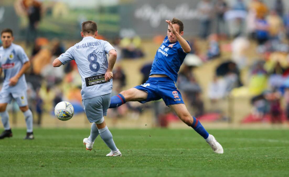 Angus Thurgate (right) challenges for the ball in a match against Central Coast on August 25. Photo: Jonathan Carroll