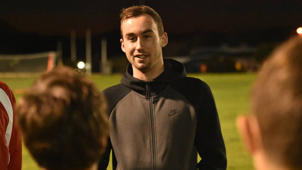 Listen up: Angus Thurgate has a word with Football Mid North Coast NPL players on Wednesday night. Photo: Paul Jobber