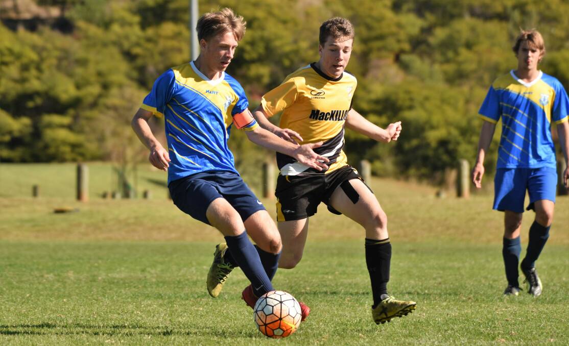 Down and out: Cayden Briscoe battles for the ball in MacKillop College's round-of-32 Bill Turner Cup clash with Coffs Harbour. MacKillop bowed out of the competition on August 20. Photo: Paul Jobber