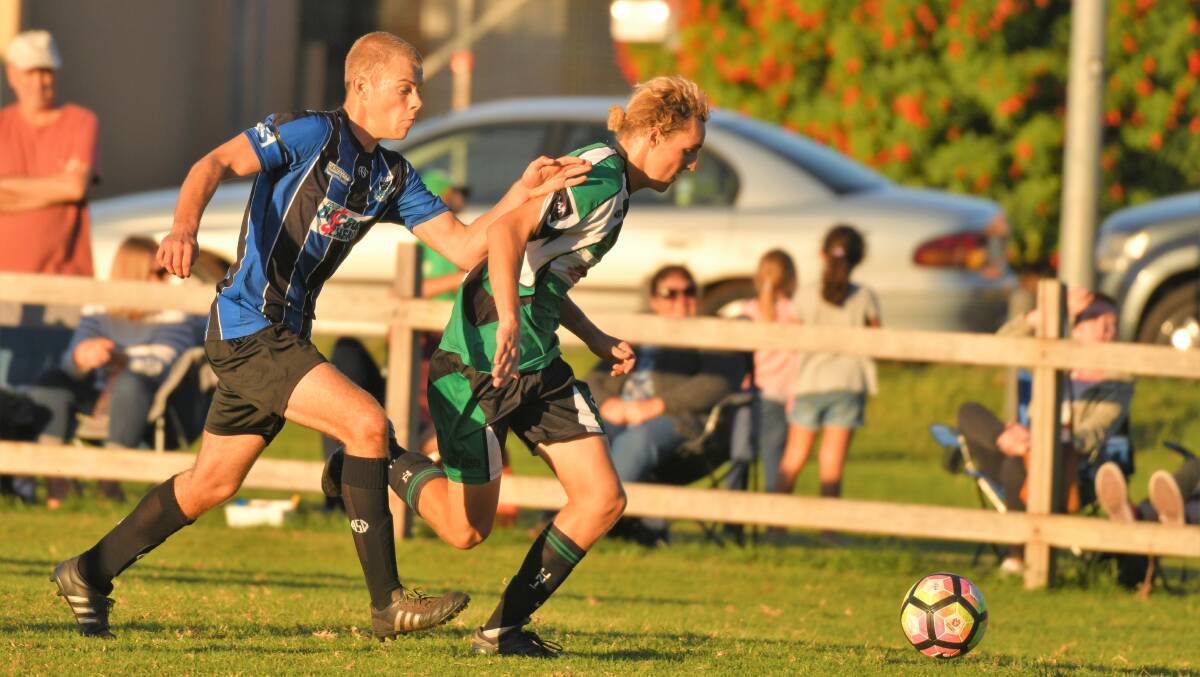Chase is on: Ty Marchant puts the pressure on Harry Gordon in the last local derby between Port United and Port Saints. Photo: Ivan Sajko