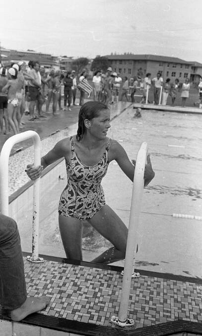 Wendy Marshall leaves the pool after winning the 50m backstroke event for 15 year olds at the High School swimming carnival, 1972