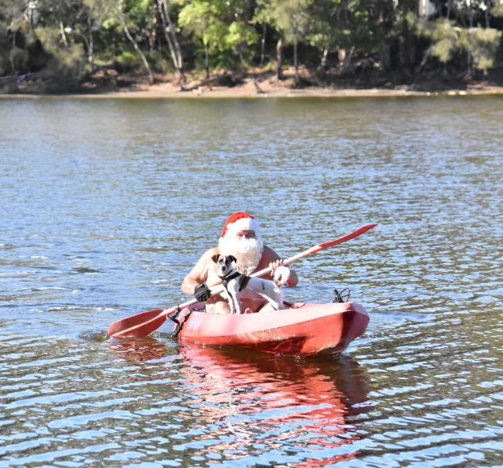 In 2018: Ruby and Santa, also known as Ron Hunter, kayaking at Lake Cathie. 