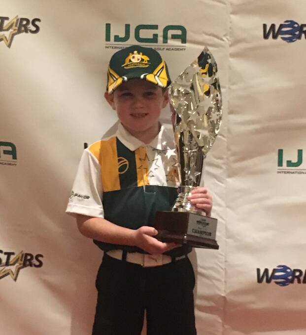 BIG PRIZE: Greta golf prodigy Harry Preece with his world stars trophy in Las Vegas last month. Harry's father is from Wauchope and he visits often. Picture: Supplied