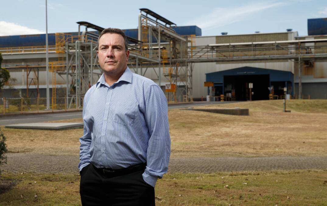 WAITING FOR MORE DETAIL: Matt Howell in front of the Tomago Aluminium smelter. Picture: Max Mason-Hubers