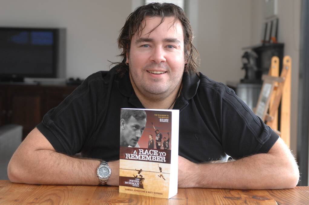Matt Norman with his book A Race to Remember, in 2008. Picture: Lachlan Bence