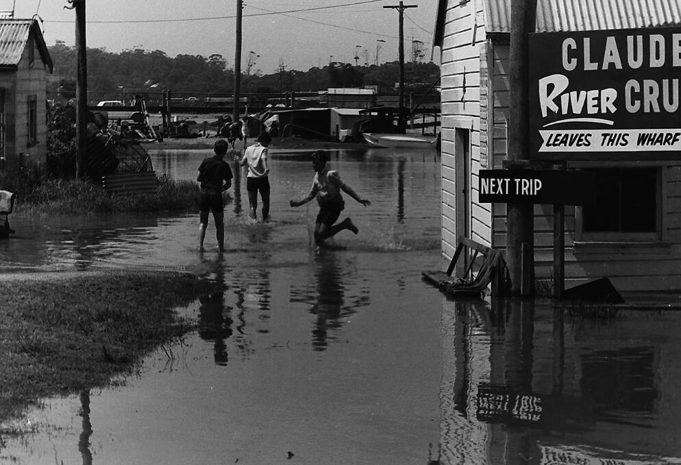 Children in 1968 playing in flood waters at the end of Clarence Street. PHOTO: Port Macquarie Historical Museum.