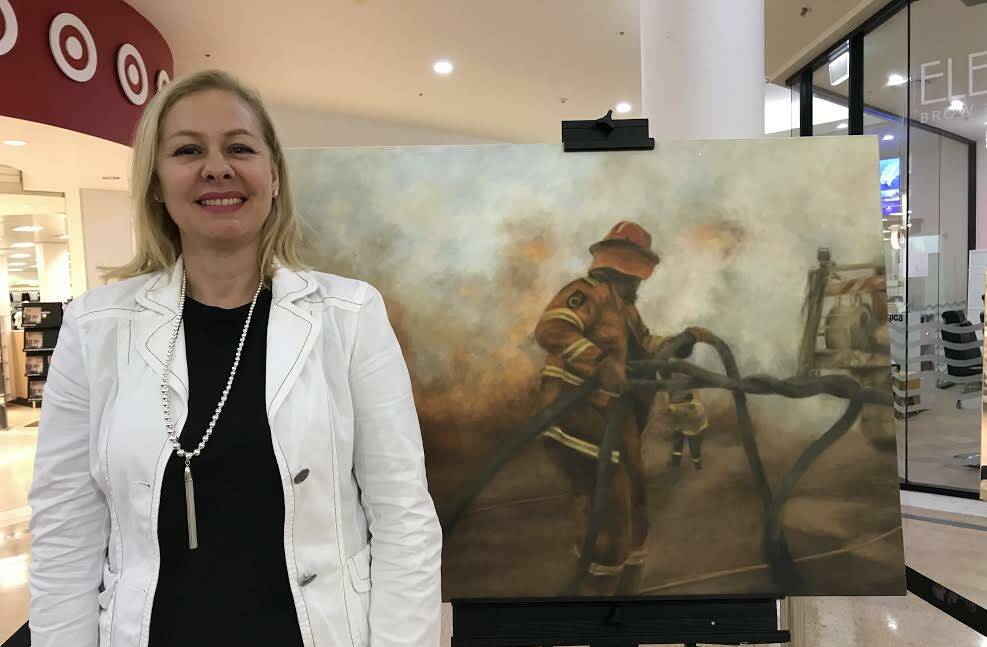 Antonija Gros in front of her painting outside Target in Port Central.