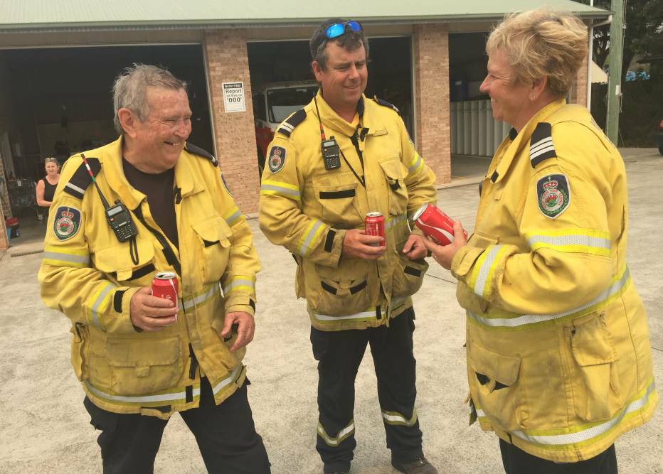 SHARING A LAUGH: The Wauchope RFS brigade take a quick break after fighting the Crestwood fire in Lake Cathie. Photo: Carla Mascarenhas