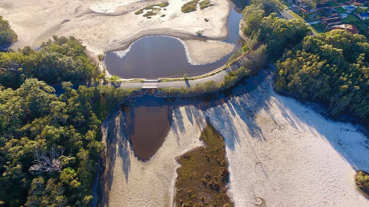 Shrinking waterway: the lake at Kenwood Drive Bridge at Lake Cathie is drying up.