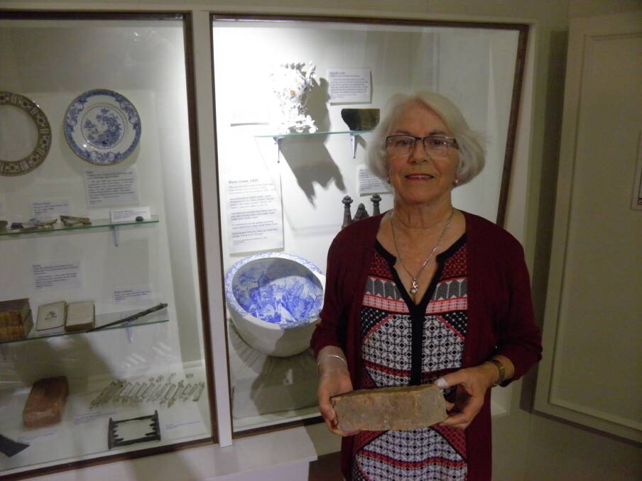Museum volunteer Anne Oud with some of the archaeological relics from Lake Innes on exhibition at the Port Macquarie Museum.