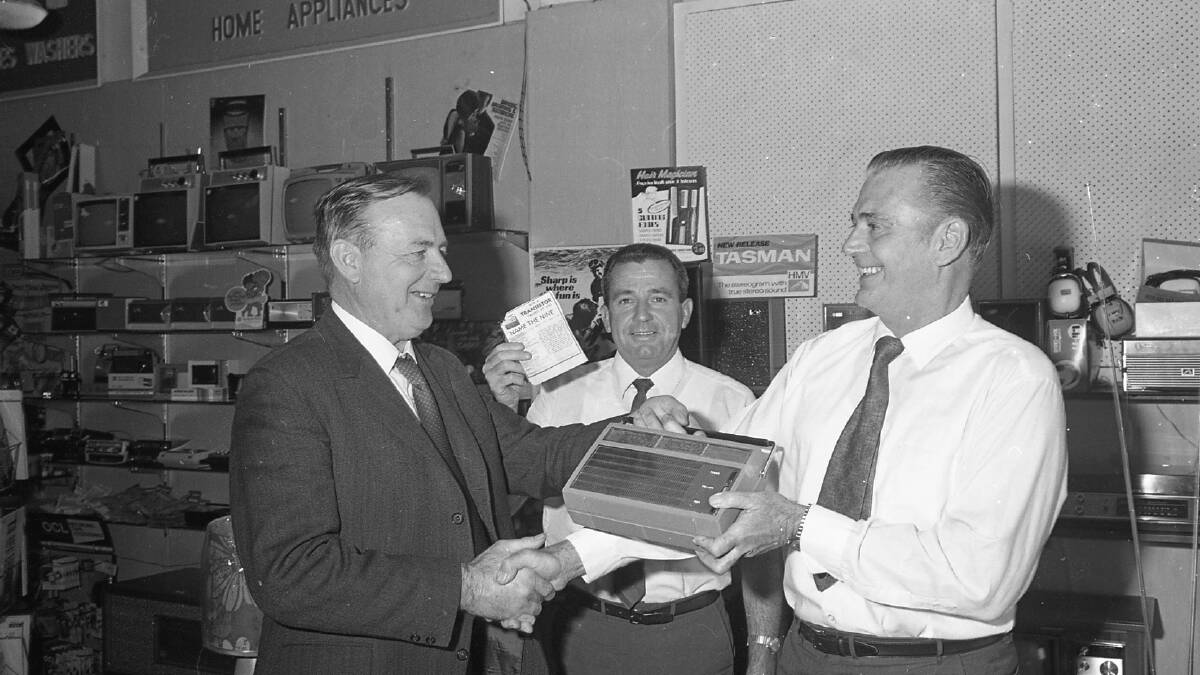 Lucky guess: Jim Boardman receives his Name the Nine prize from Warwick St Clair, watched on by Surf Lifesaving Club president, Jim Pollock holding the winning entry, 1971.