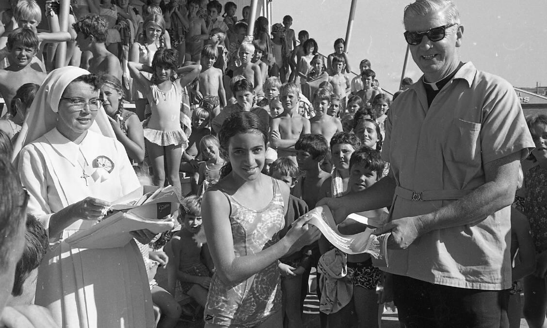 Helen Abi-Saab receives the Wauchope schools second place swimming pennant from Father Leo Donnelly, 1972.