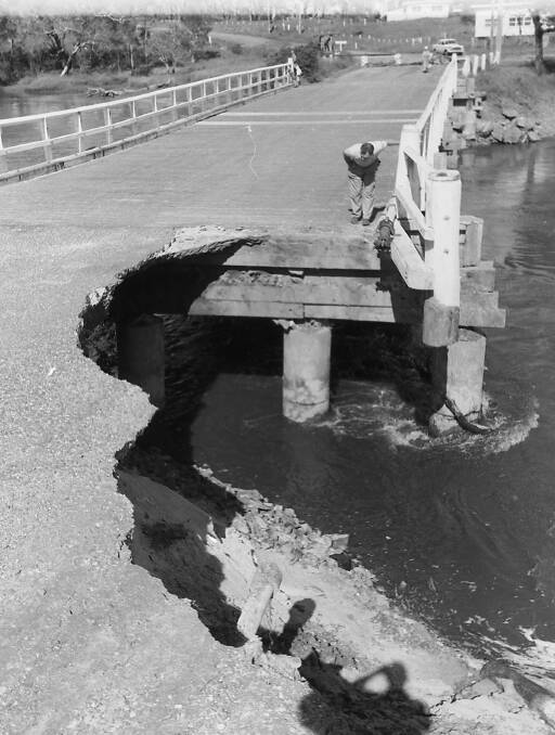 Watch your step: Inspecting damage to Cathie Bridge following flooding rain in 1963. Photo supplied by Port Macquarie Museum.