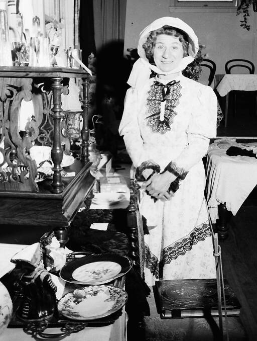 Sign of the times: Mrs Allan, wife of the Presbyterian Minister, in period dress at the craft and antique exhibition, 1968.