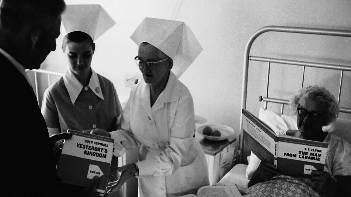 Easy reading: Vic French, Lions Club president, hands over the donation of large print books to Hastings District Hospital Matron Bailey, 1969.