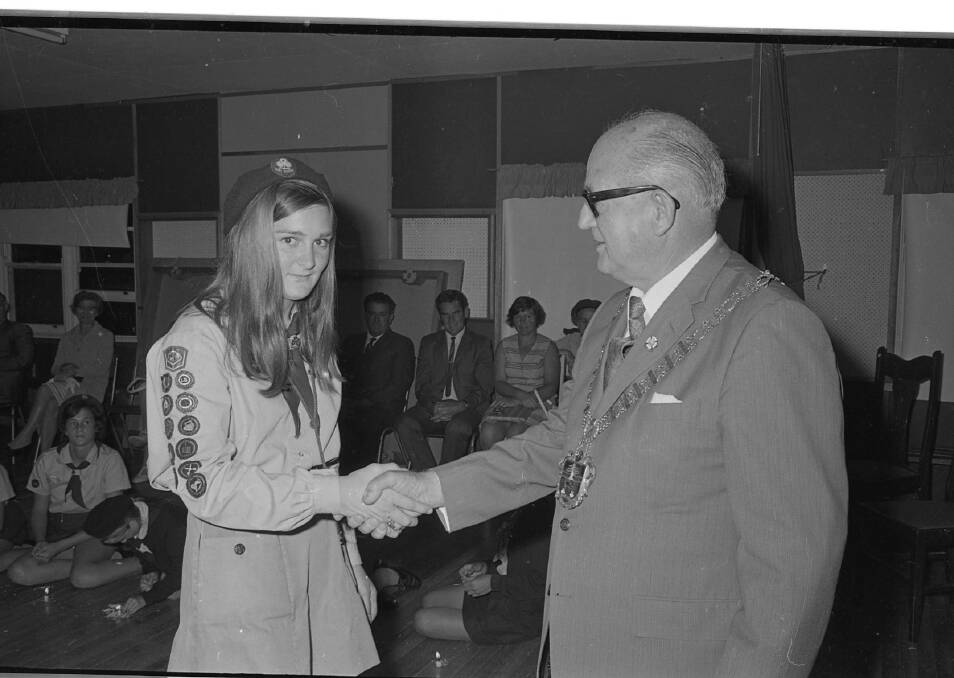 Well done: Mayor C.C. Adams congratulates Rhonda Plews on obtaining her Queens Guide badge award, 1971. Photos: supplied by Port Macquarie Museum.
