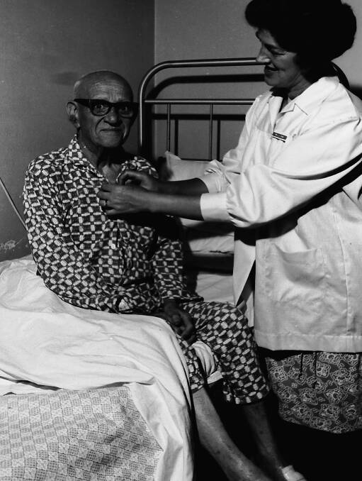 Thank you: Mrs Gown, Pink Ladies secretary, assists Aub Jones, at Hastings District Hospital, 1970. 