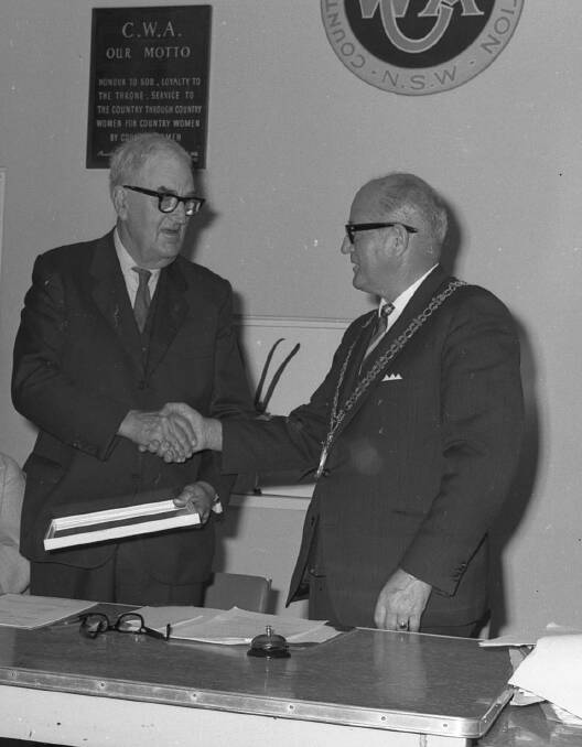 Recognition: Former mayor A.C. Elliot receives a certificate of appreciation from Mayor C.C. Adams, 1968.
 
