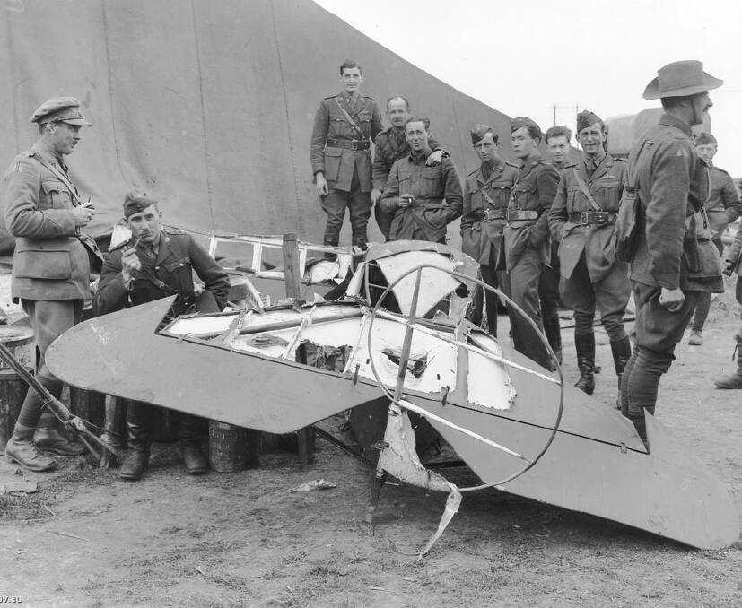 Red wreckage: The mangled aircraft belonging to The Red Baron attracted dozens of souvenir hunters who were sent packing by Aussie Diggers. Photo: Wilkins family.