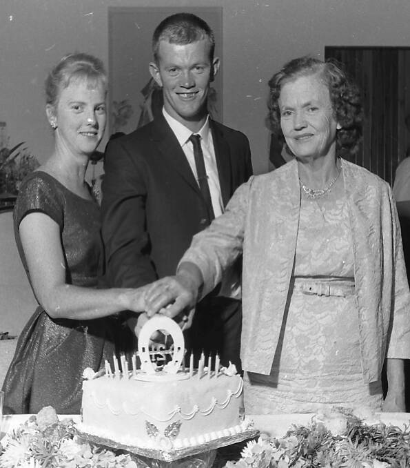 Celebration: Lloyd Eyles cuts his 21st birthday cake with this sister Sonya and his mother, at the party attended by about 100 people, 1963.