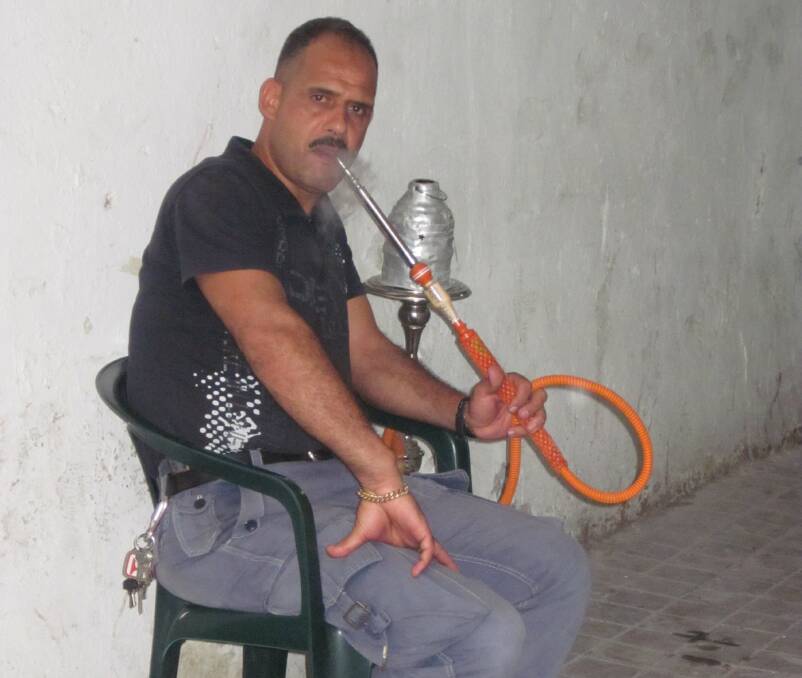 Tunis memories: A local Tunisian smoking a hookah pipe, gave it up to traveller Malcolm Andrews for $40 US.