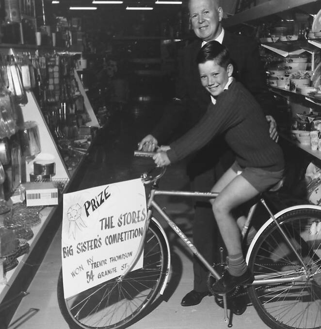 Congratulations: Manager of the Co-op stores, H B. Hansford presents Trevor Thompson with his winning prize in the Big Sister Win a Bike competition, 1969.