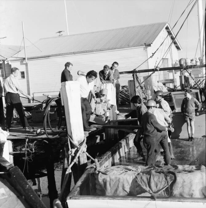 Rescue mission: Loading the Mathew Flinders repaired pump on to Merv Radleys fishing trawler, 1970.