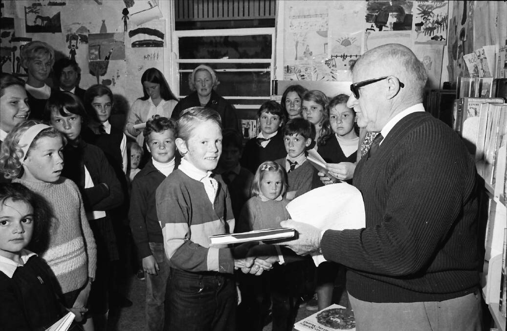 Well done: Mr. W. de la Rue presents a Book Week prize to a happy young recipient, 1971.