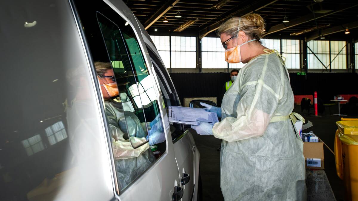 Health workers don facemasks, goggles, gloves and gowns to protect themselves while working at the COVID-19 drive-through testing centre at EPIC, Canberra. Picture: Karleen Minney