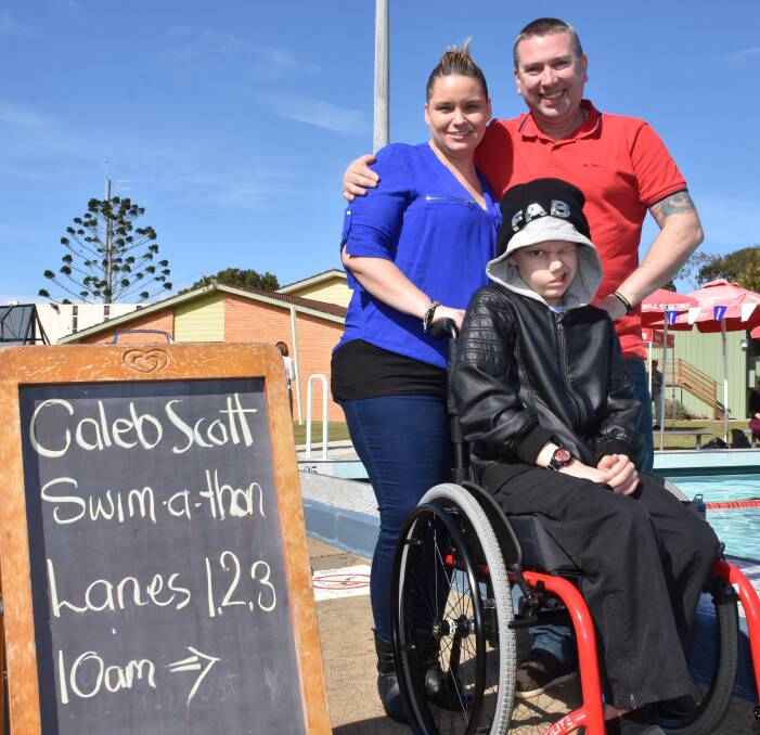 Lanes open: Suzanne and Rob Turpie with Caleb at the swim-a-thon. Photo: Ivan Sajko