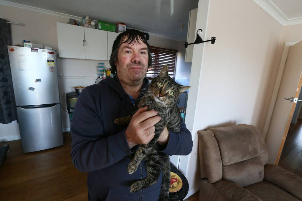 Mr Gilbert is allowed to keep Charlie the cat for company, but feeding and looking after a pet is yet another cost he must factor into his tight budget. Picture: Rodney Braithwaite