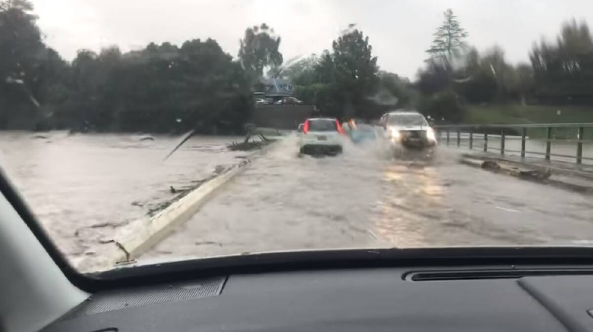 Dashcam image of cars rushing over Lavenders Bridge Bellingen before it closed this morning