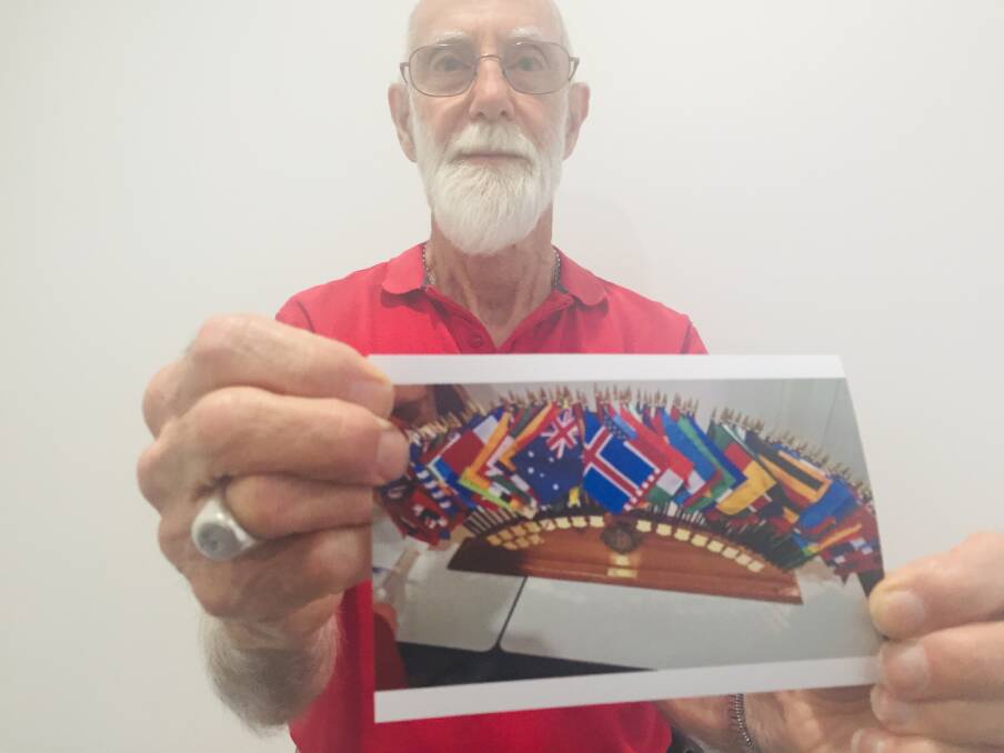 STOLEN: Fred Hynes with a picture of the flag set that was stolen from his home. PHOTO: Laura Telford.