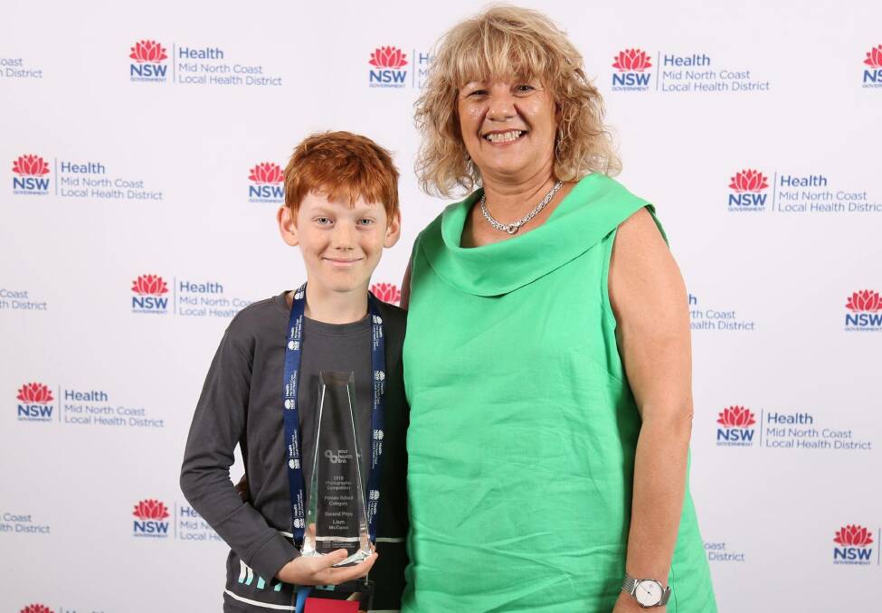 CONGRATULATIONS: Liam McCann with his award which was presented by Jodie Eyre NSW Deptartment of Education. 